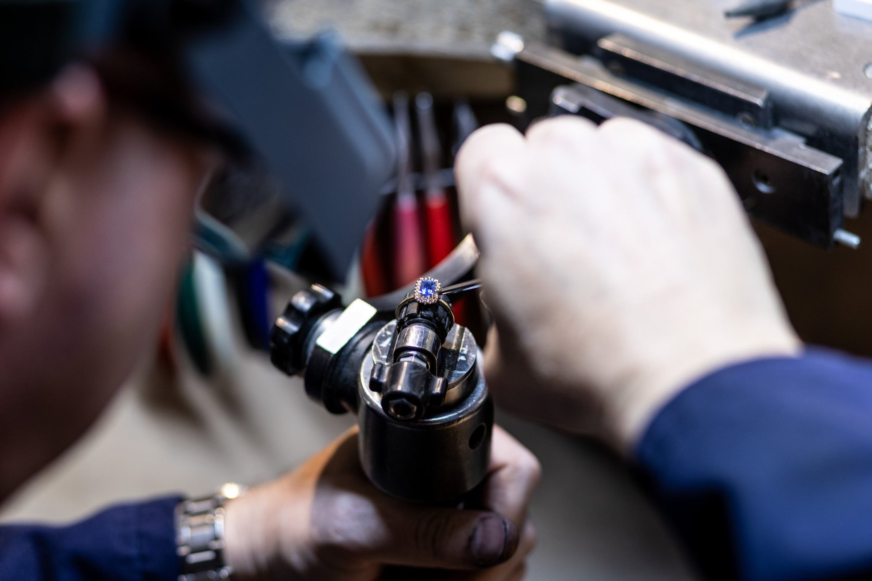 A sapphire ring being hand-set at the workshop bench at The Diamond Setter